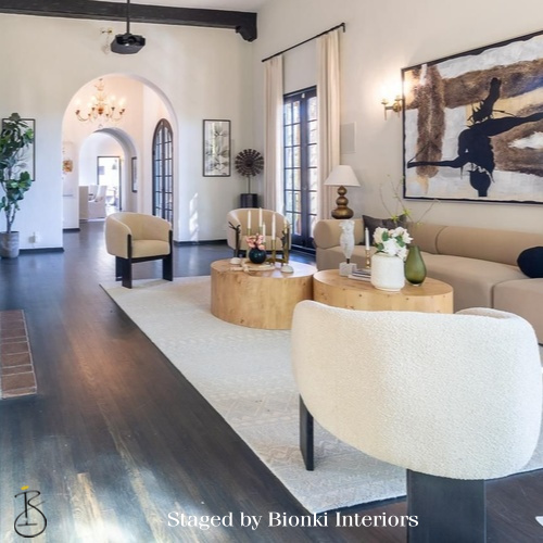 Luxury open-concept living room staging featuring arched architectural details and statement artwork. Staged by Bionki Interiors.