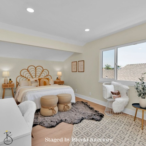 Luxury primary bedroom staging with soft neutral tones, layered bedding, and sculptural accents designed to create a calm, market-ready retreat. Staged by Bionki Interiors.