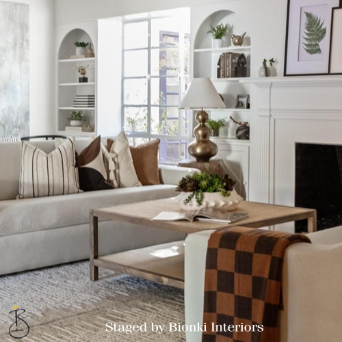 Luxury living room staging featuring built-in shelving and a fireplace focal point. Staged by Bionki Interiors.