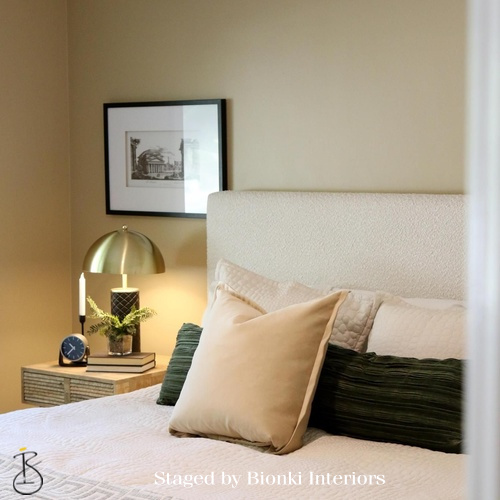 Luxury bedroom detail styling featuring layered pillows, soft neutral textiles, and refined bedside accessories. Styled by Bionki Interiors.