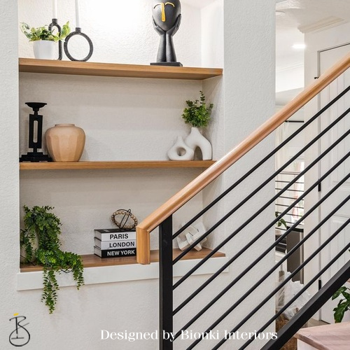 Custom interior design featuring open shelving, integrated stair detailing, and layered textures. Designed by Bionki Interiors.