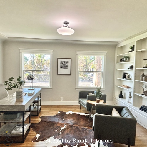 Luxury open-concept living and dining staging featuring built-in shelving and flexible layout design. Staged by Bionki Interiors.
