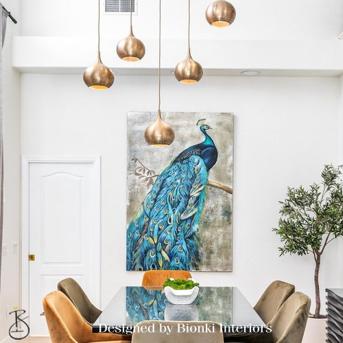 Custom dining space design featuring statement pendant lighting and curated artwork. Designed by Bionki Interiors.