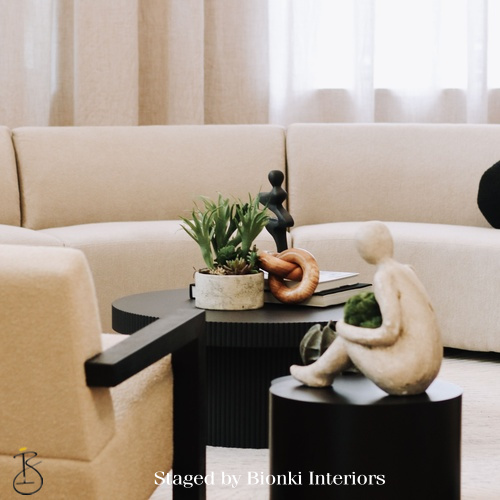Luxury living room detail styling featuring sculptural accessories, layered textures, and soft neutral upholstery designed to add warmth and visual interest. Styled by Bionki Interiors.