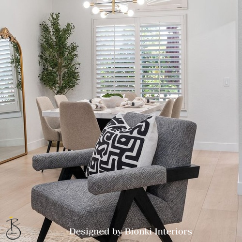 Custom dining area design featuring sculptural accent seating and a neutral palette. Designed by Bionki Interiors.