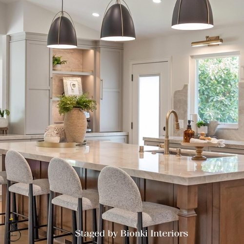 Luxury kitchen staging featuring a statement island and sculptural pendant lighting. Staged by Bionki Interiors.