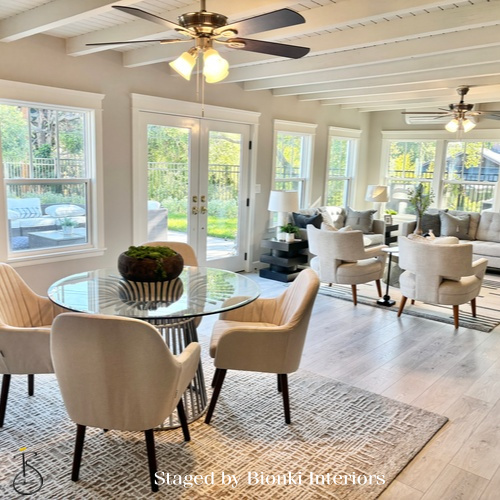 Luxury open-concept living and dining staging with seamless indoor-outdoor flow. Staged by Bionki Interiors.